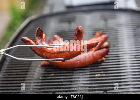 Delicious smoked sausages on the barbecue garden grill Stock Photo