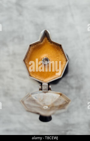 Moka pot with fresh brewed coffee on grey background Stock Photo