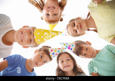 Cute little children in Birthday hats at party, bottom view Stock Photo