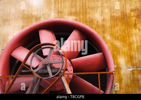 Landschaftspark Duisburg, Germany: Close up of red turbine with driving belt and rusty steel wall Stock Photo