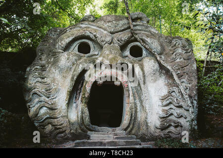 Orcus mouth sculpture at famous Parco dei Mostri (Park of the Monsters), also named Sacro Bosco (Sacred Grove) or Gardens of Bomarzo in Bomarzo Stock Photo