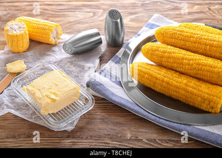 Composition with boiled corncobs on wooden table Stock Photo
