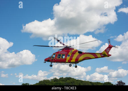 An Essex & Herts air ambulance helicopter landing in Hertford, UK. The helicopter landed in Perrett Gardens. Stock Photo