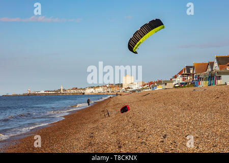 A young teenage boy flies his kite on the beach at Herne Bay, ready to go Kite Boarding, Kent, UK Stock Photo