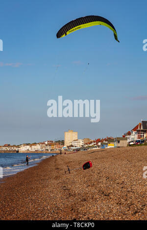 A young teenage boy flies his kite on the beach at Herne Bay, ready to go Kite Boarding, Kent, UK Stock Photo
