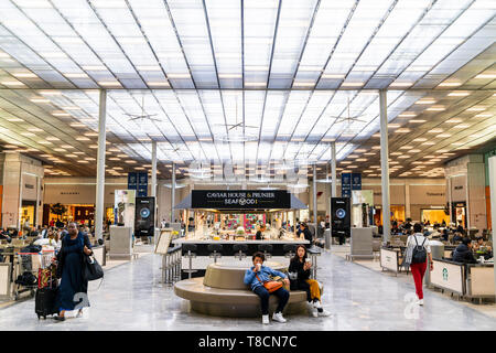 Charles De Gaulle Airport, interior. Main central departure lounge area of Terminal 2E, with Caviar House and Prunier seafood in center and seating. Stock Photo