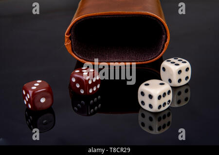 Dice with dice cup on black background Stock Photo