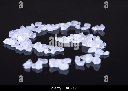 With salt crystals written on a black background an S Stock Photo