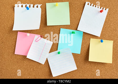 colored paper stickers on cork board background Stock Photo