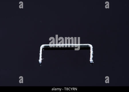a single isolated tacker on a black background Stock Photo