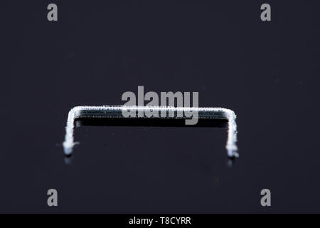 a single isolated tacker on a black background Stock Photo