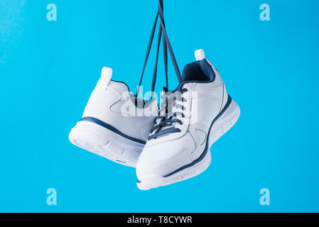 Fashion male sport shoes on blue background. Stylish man sneakers for fitness, close up Stock Photo