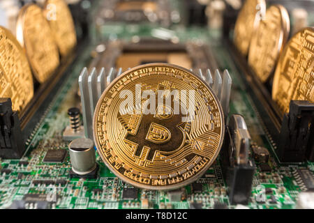 Bitcoin close-up on a computer circuit motherboard as a blockchain technology payment network. Digital cryptocurrency concept and mining. Stock Photo