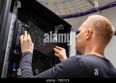 IT Consultant Working With Servers In Large Enterprise Datacenter Stock Photo
