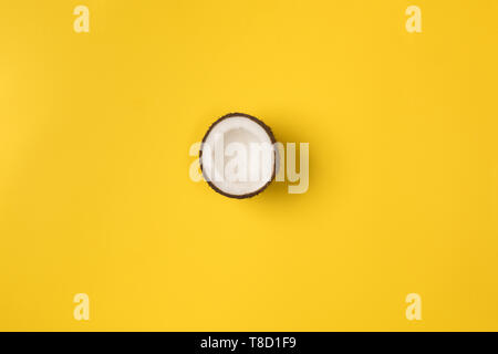 Summer composition. Coconut on yellow background. Summer concept. Flat lay, top view, copy space Stock Photo