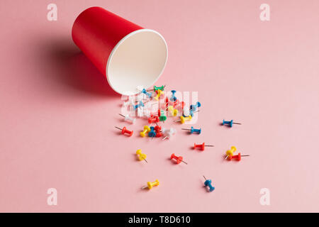 sprinkled colorful different pins in the open bottle.close up top view photo.Chancellery concept Stock Photo