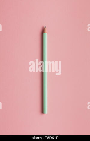 Close up top view photo of a wood pencil isolated on pink background. necessary useful tool for student. Stock Photo