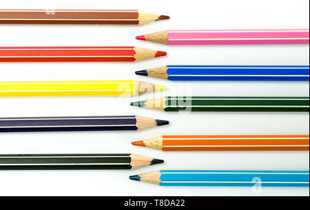 horizontal view of colored pencils facing each other on a white background Stock Photo
