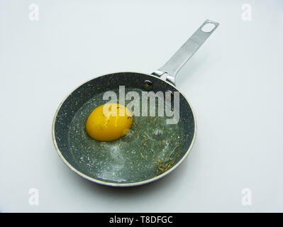 Fried egg in a frying pan on a white background Stock Photo