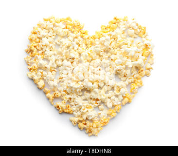 Heart made of delicious popcorn on white background Stock Photo