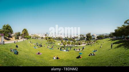 Panorama view of people enjoying the sunny weather in Mission Dolores Park, San Francisco, USA Stock Photo