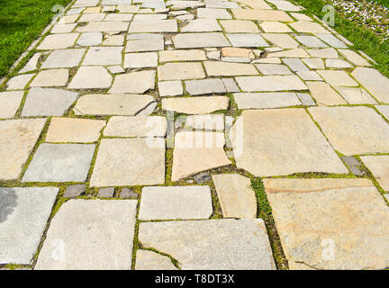 Stone blocks pavement in the city park.Pathway made with big asymmetrical stones Stock Photo