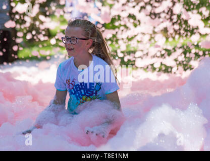 Weymouth, Dorset, UK. 12th May 2019. Weldmar's last ever Bubble Rush takes place at Weymouth to raise funds for the charity. Participants have fun getting covered in foam, running through bubbles of different colours. Credit: Carolyn Jenkins/Alamy Live News Stock Photo