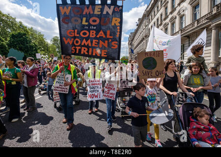 London, UK. 12th May 2019. Women of Colour in the Global Women's Strike on the XR International Mothers Day March by several thousand mothers, children and some fathers from Hyde Park Corner to a rally filling Parliament Square, backing Extinction Rebellion's call for the drastic and urgent action needed to avert the worst consequences of climate change, including possible human extinction. Our politicians have declared a climate emergency but now need to take real action rather than continuing business as usual which is destroying life on our planet. Peter Marshall/Alamy Live News Stock Photo