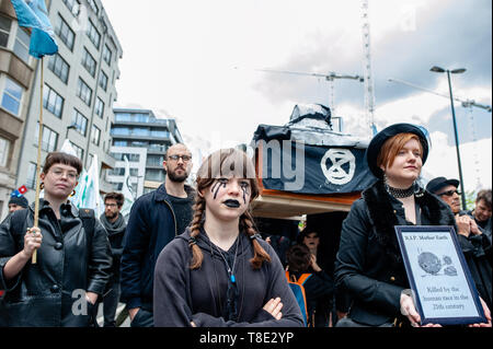 Brussels, Belgium. 12th May, 2019. Activists from Rebellion Extinction are seen recreating a funeral while wearing black clothes and black make up during the march.Thousands of people gathered at the North Station in Brussels during a march for the climate and social justice for all. With the imminent European elections, several organizations launched this demonstration to unite the climate movement, for social justice and against racism, to uphold their fundamental rights. Credit: Ana Fernandez/SOPA Images/ZUMA Wire/Alamy Live News Stock Photo