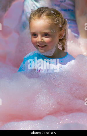 Weymouth, Dorset, UK. 12th May 2019. Weldmar's last ever Bubble Rush takes place at Weymouth to raise funds for the charity. Participants have fun getting covered in foam, running through bubbles of different colours. Credit: Carolyn Jenkins/Alamy Live News Stock Photo