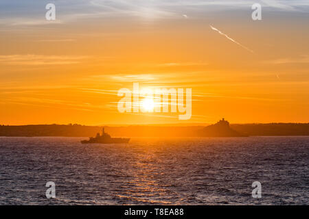 Newlyn, Cornwall, UK. 13th May 2019. A fresh breeze and a glorious sunrise for the crew of HMS Enterprise, anchored overnight in Mounts Bay. Credit Simon Maycock / Alamy Live News. Stock Photo