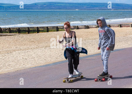 Bournemouth, Dorset, UK. 13th May 2019. UK weather: sunny at Bournemouth beaches with a slight cooling breeze, as visitors head to the seaside to make the most of the sunshine.  Skateboarders skateboarding along the promenade. Teens on a skateboard, skate board, skateboards, skate boards, skate boarding, skateboarders, skateboarder, skate boarders, skate boarder.  Credit: Carolyn Jenkins/Alamy Live News Stock Photo