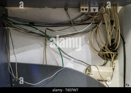 tangled network cables and wires in server room Stock Photo