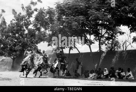 African tribesmen racing horses in Cameroon village Africa 1959 Stock Photo