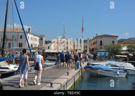 View from the harbor to Piazza Giacomo Matteotti with the Church of San Nicolo and Severo in Bardolino on Lake Garda - Italy. Stock Photo