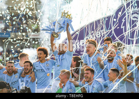 Vincent Kompany of Manchester City lifts the Premier League trophy after the Premier League match between Brighton & Hove Albion and Manchester City  at the American Express Community Stadium 12 May 2019 Photo Simon Dack / Telephoto Images Editorial use only. No merchandising. For Football images FA and Premier League restrictions apply inc. no internet/mobile usage without FAPL license - for details contact Football Dataco Stock Photo