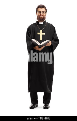 Full length portrait of a father priest with a cross and bible isolated on white background Stock Photo