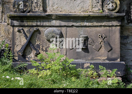 Weathered memorial with various symbols in Old Calton Burial Ground, Edinburgh, Scotland, UK Stock Photo