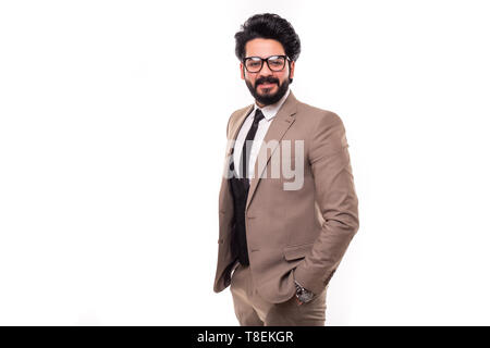 Young man wearing a suit standing hands in pocket smiling isolated on a white background. Stock Photo