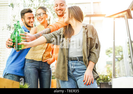 Happy friends cheering with beers in bar restaurant outdoor - Young people having fun drinking and toasting alcohol Stock Photo