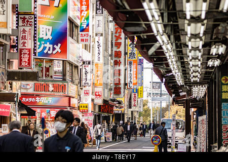 Tokyo, Japan - october 30 2013 : people walking in the street in the front of the famous yodobashi camera electronics store in Shinjuku Stock Photo