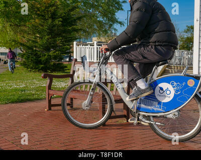 Cardiff public hire bicycles being used by youths on the street in Cardiff Bay Stock Photo