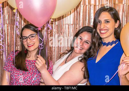 Murcia, Spain May 12, 2019: Birthday friends parties. Attractive women celebrate special dates. Familiar gathering. Happy woman smile with balloons at a party. Stock Photo