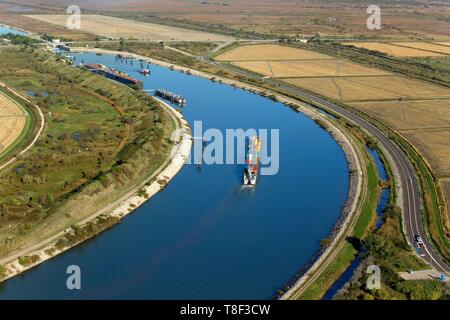 France, Bouches du Rhone, Port Saint Louis du Rhone, entry of a container barge in the Barcarin lock on the Rhone navigation channel at the port of Fos sur Mer (aerial view) Stock Photo