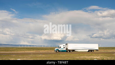 White big rig semi truck with cargo trailer on a Utah Highway Stock Photo