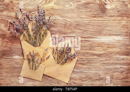 Open mail envelopes with lavender flowers on wooden background Stock Photo