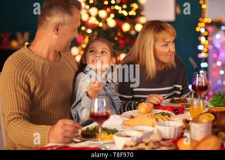 Happy family having Christmas dinner at home Stock Photo