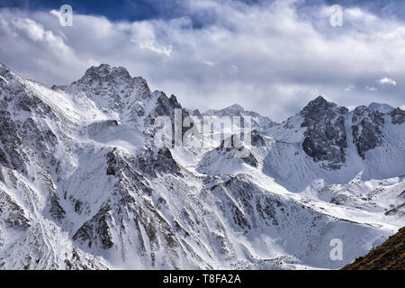 Snow covered mountain peaks of Eastern Sayan. April. Munku-Sardyk massif. Buryatia. Russianull Stock Photo
