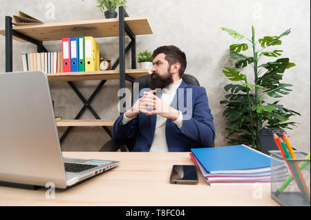 thinking over new business strategy. Planning marketing strategy. Brutal businessman think in office. Mature man use computer. Male boss working. We should use this strategy. Developing new strategy. Stock Photo