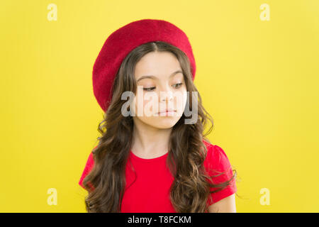 Kid girl long healthy shiny hair. Perfect curls. Kid cute face with adorable curly hairstyle wear beret hat. Little fashionista. Little girl grow long hair. Styling of curly hair. Hairdresser service. Stock Photo